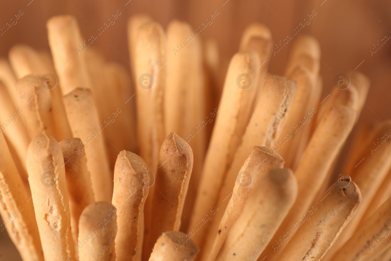 Photo of Many fresh delicious grissini sticks, closeup view