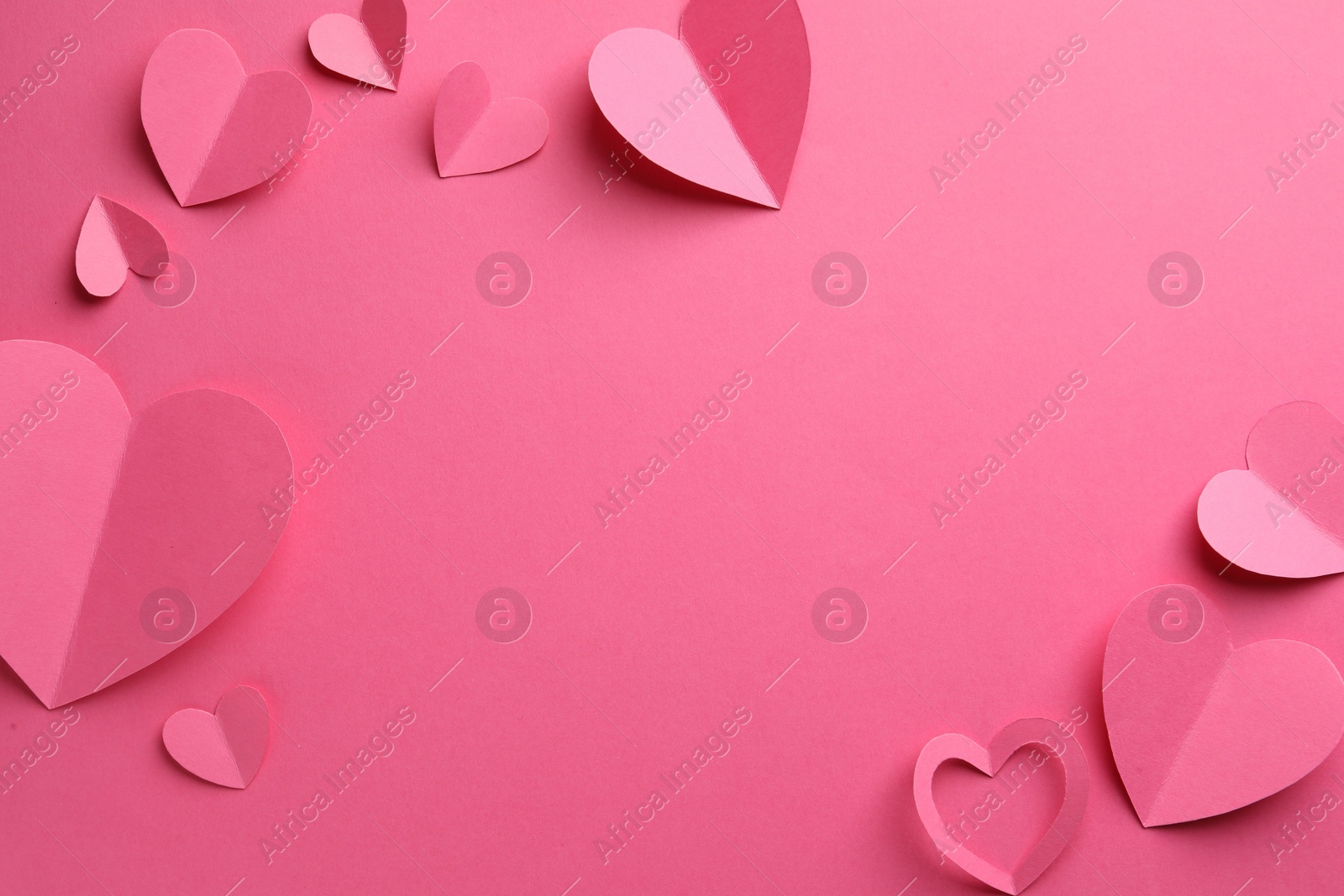 Photo of Paper hearts on pink background, flat lay. Space for text