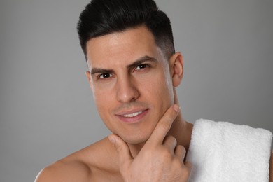 Photo of Handsome man after shaving on grey background, closeup