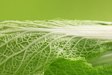 Photo of Fresh ripe Chinese cabbage on light green background, closeup