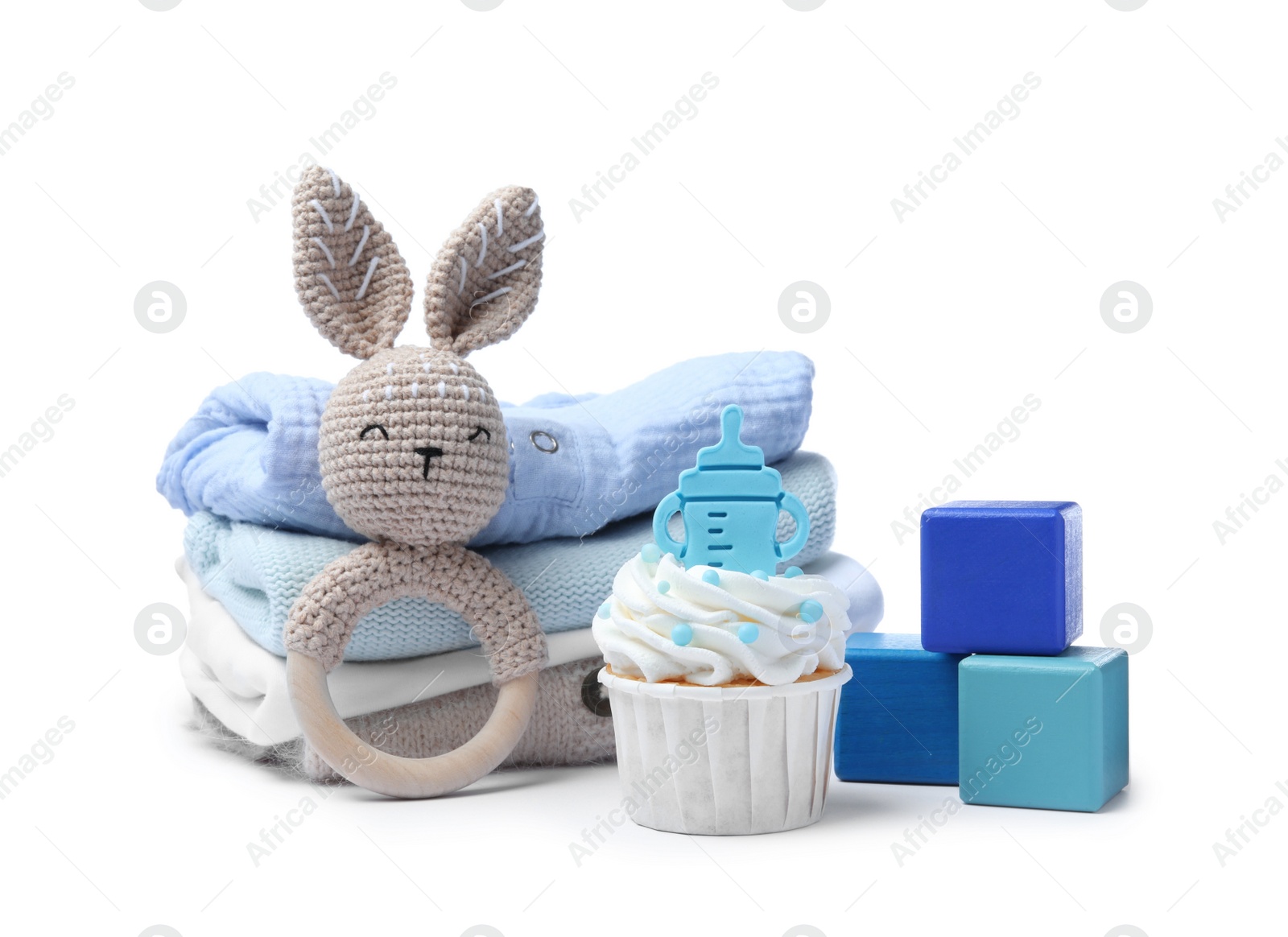 Photo of Beautifully decorated baby shower cupcake for boy, clothes and toys on white background