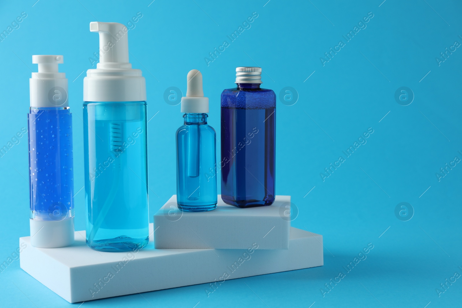 Photo of Set of luxury cosmetic products on light blue background. Space for text