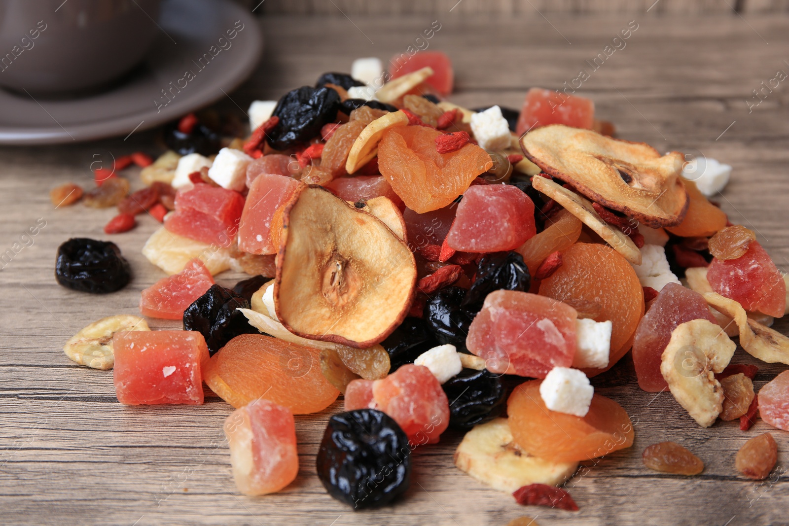Photo of Different tasty dried fruits on wooden table