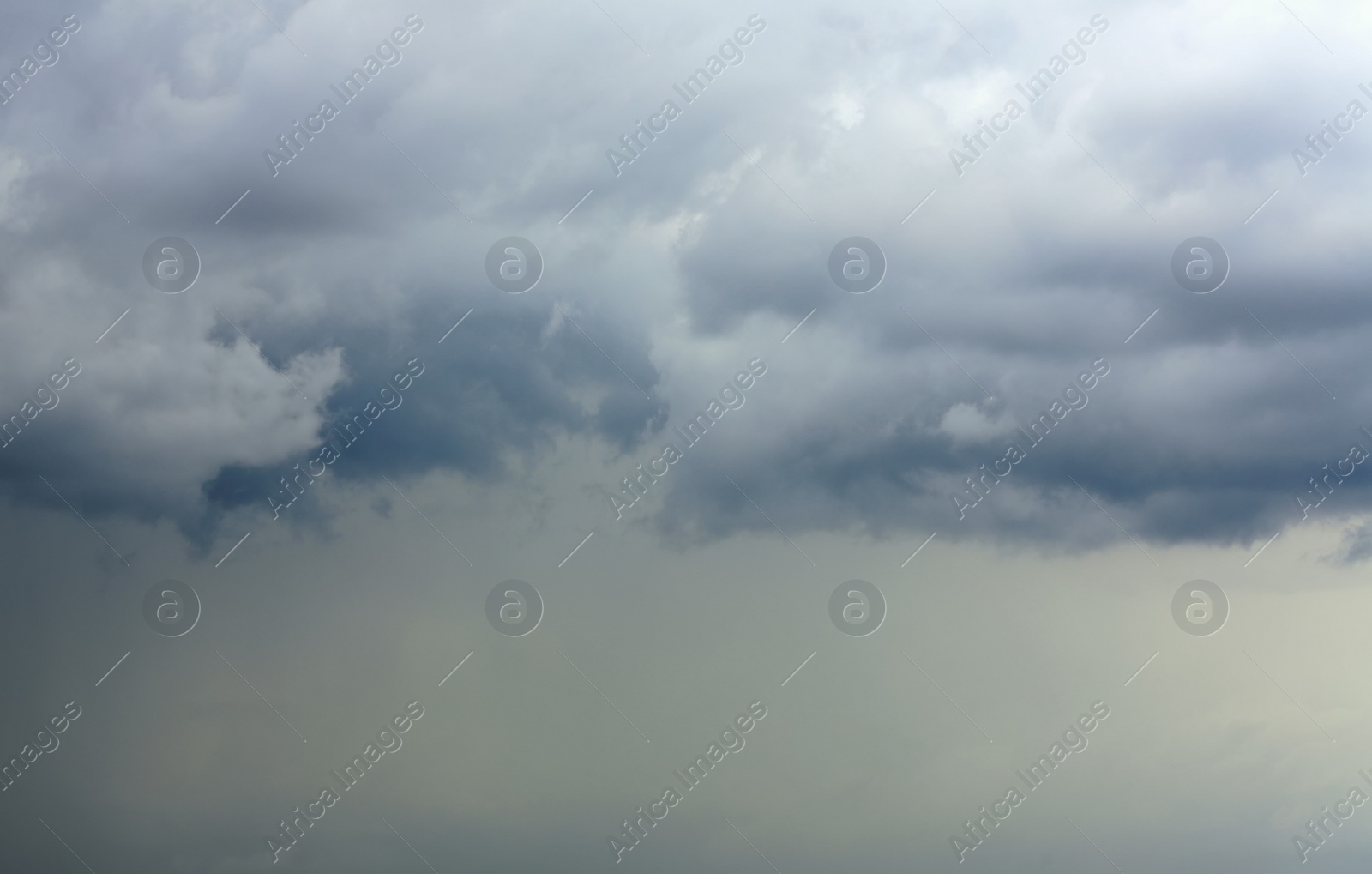 Photo of Sky with heavy rainy clouds on grey day