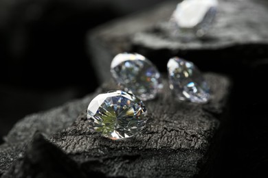 Beautiful shiny diamonds on coal, closeup view