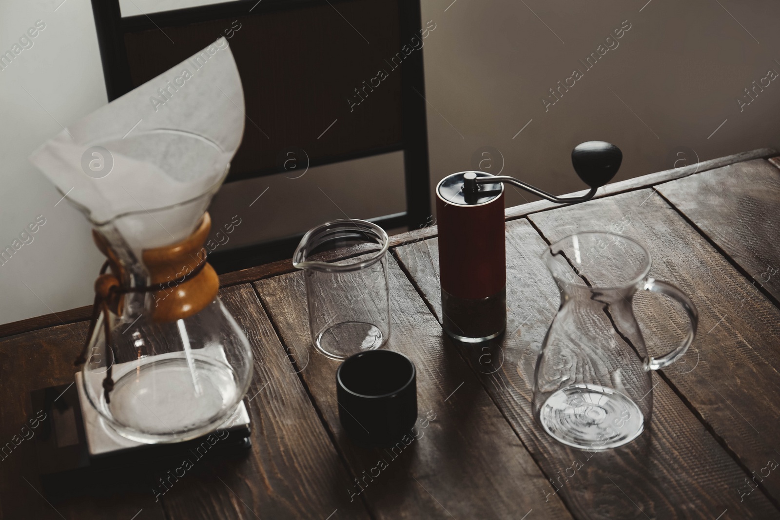 Photo of Dishware for coffee making on wooden table in cafe