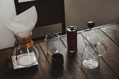 Dishware for coffee making on wooden table in cafe