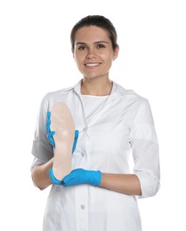 Photo of Beautiful female orthopedist showing insole on white background