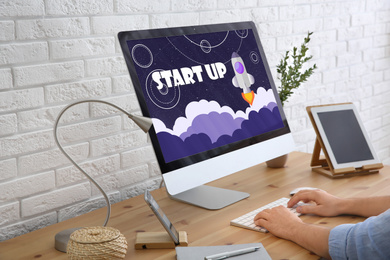 Startup business concept. Young man using computer in office, closeup  