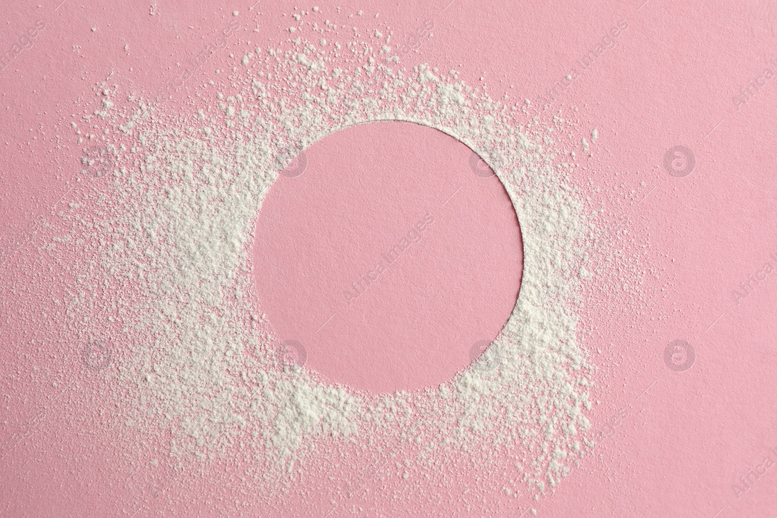 Photo of Frame made of rice loose face powder on pink background, top view. Space for text