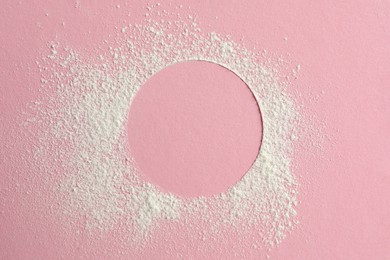 Photo of Frame made of rice loose face powder on pink background, top view. Space for text