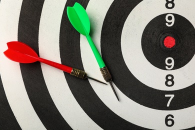 Photo of Red and green arrows on dart board, top view