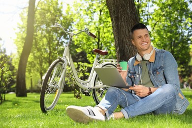 Photo of Man taking coffee break during work in park