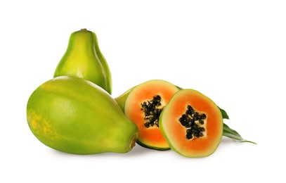 Fresh ripe papaya fruits with green leaves on white background