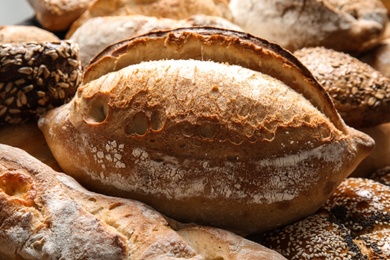 Different kinds of fresh bread as background, closeup