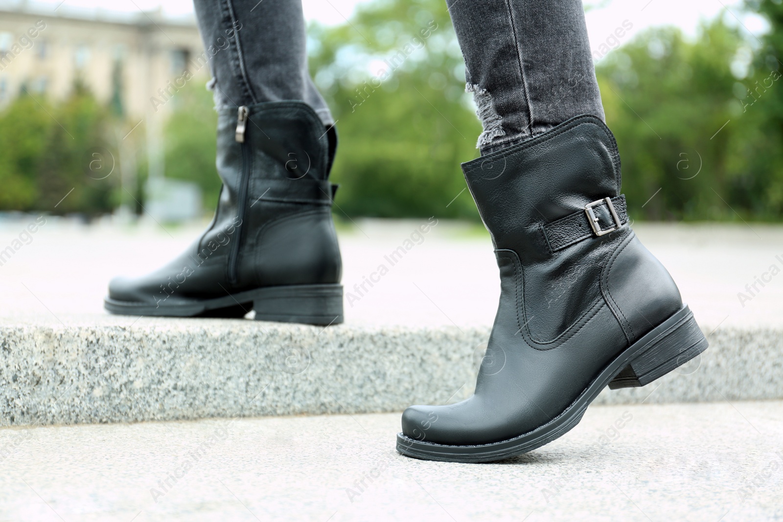 Photo of Woman wearing comfortable stylish boots outdoors, closeup