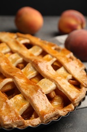 Delicious fresh peach pie on grey table, closeup