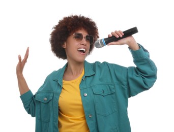 Photo of Curly young woman in sunglasses with microphone singing on white background