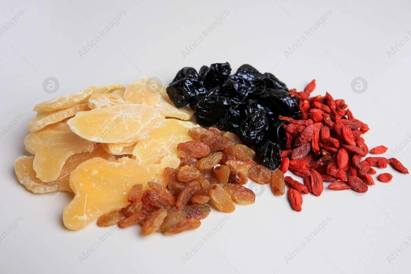 Photo of Pile of different dried fruits on white background