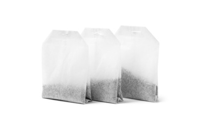 Photo of Three new tea bags on white background