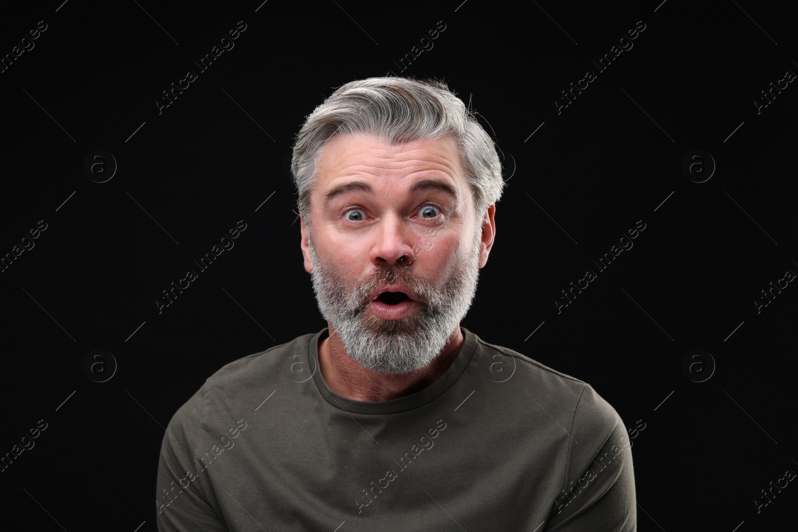 Photo of Personality concept. Portrait of emotional man on black background