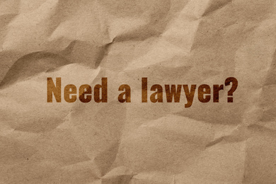 Image of Text NEED A LAWYER? on crumpled kraft paper