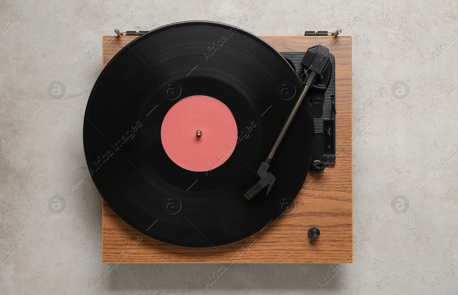 Photo of Turntable with vinyl record on light background, top view