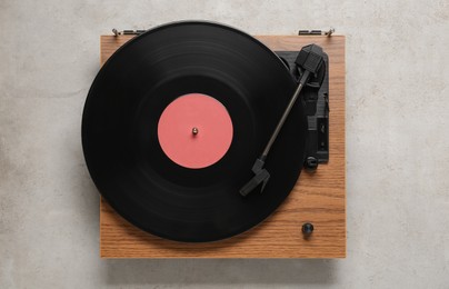 Photo of Turntable with vinyl record on light background, top view