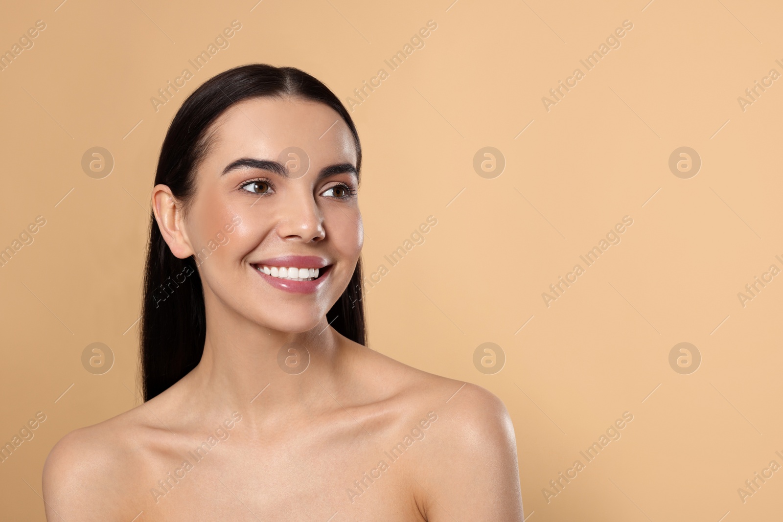 Photo of Portrait of attractive young woman on beige background, space for text. Spa treatment