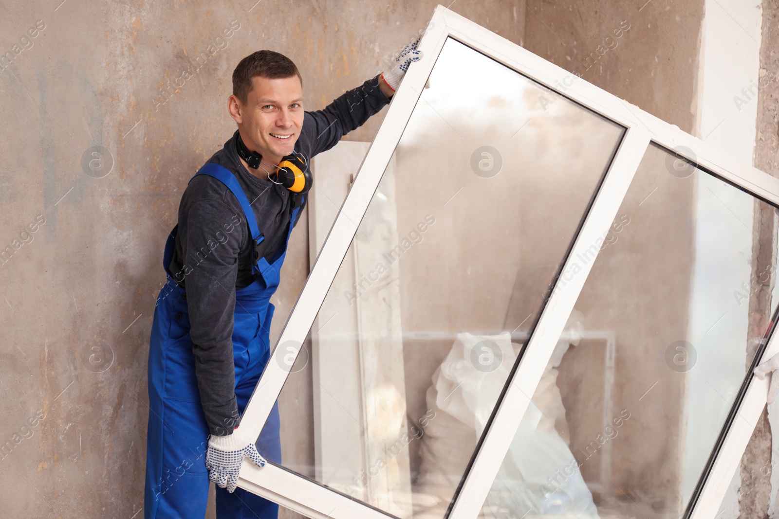 Photo of Worker in uniform with plastic window indoors