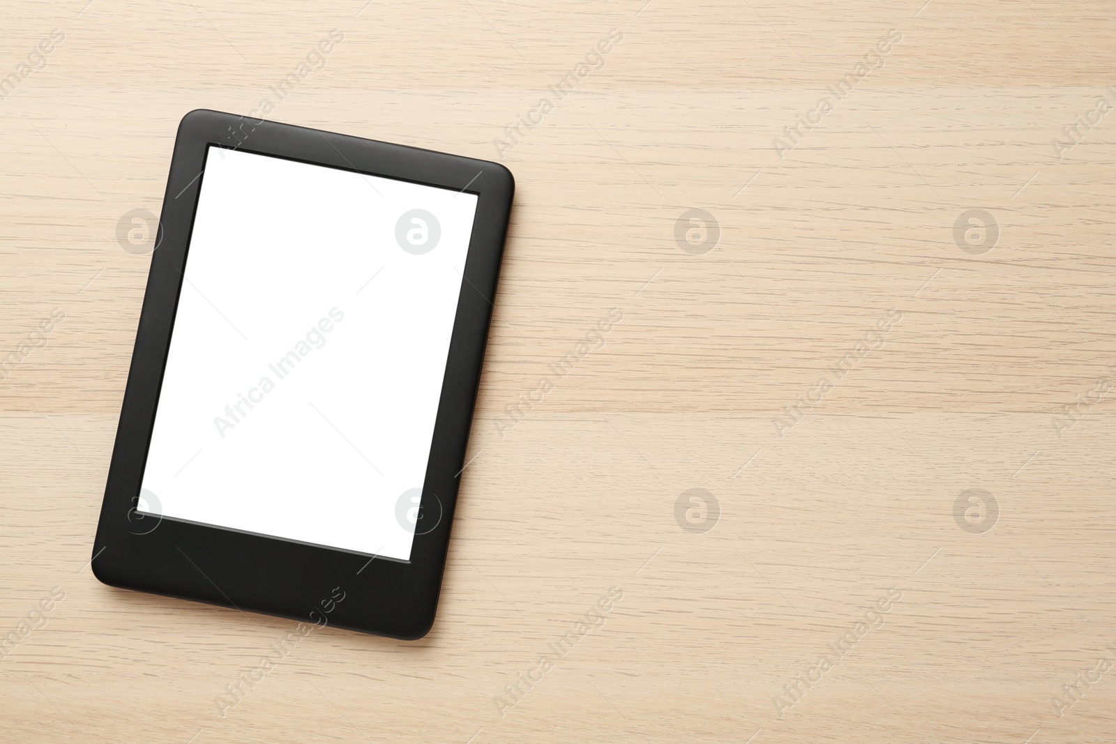 Photo of Modern e-book reader with blank screen on wooden table, top view. Space for text