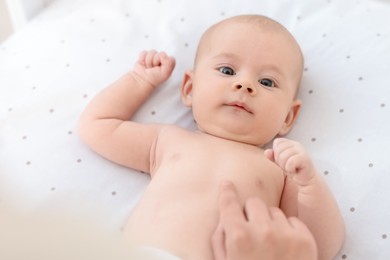 Photo of Mother with her cute little baby in crib