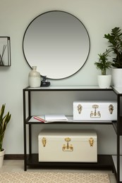 Photo of Stylish hallway interior with round mirror and rack