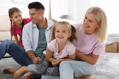 Portrait of happy family on floor at home