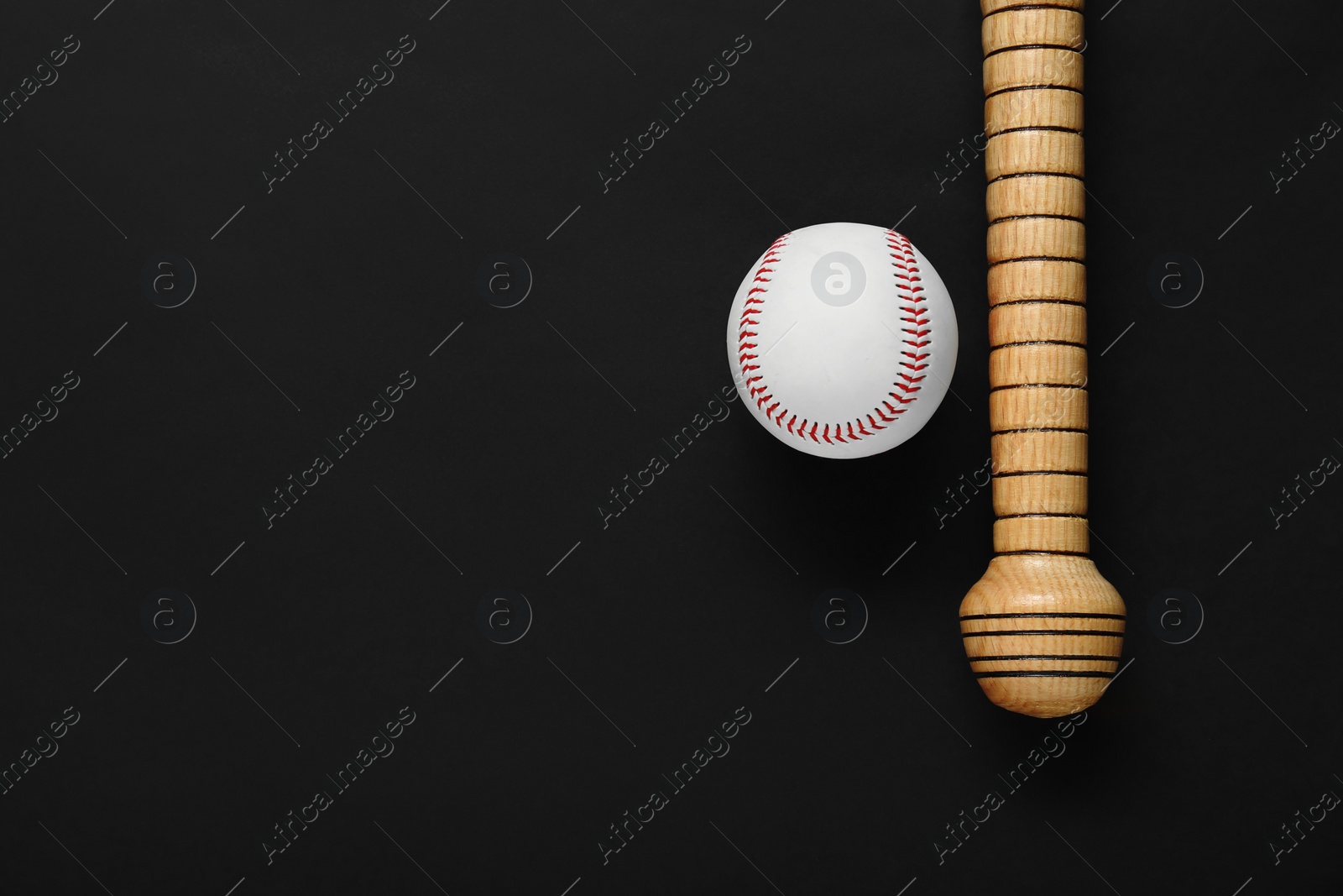 Photo of Wooden baseball bat and ball on black background, flat lay. Space for text