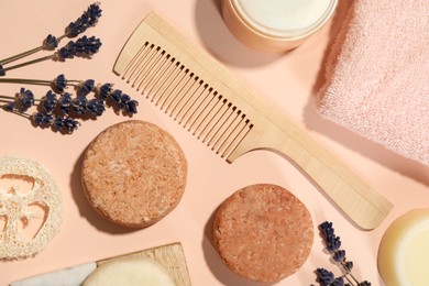 Photo of Flat lay composition of solid shampoo bars, lavender and comb on pink background. Hair care