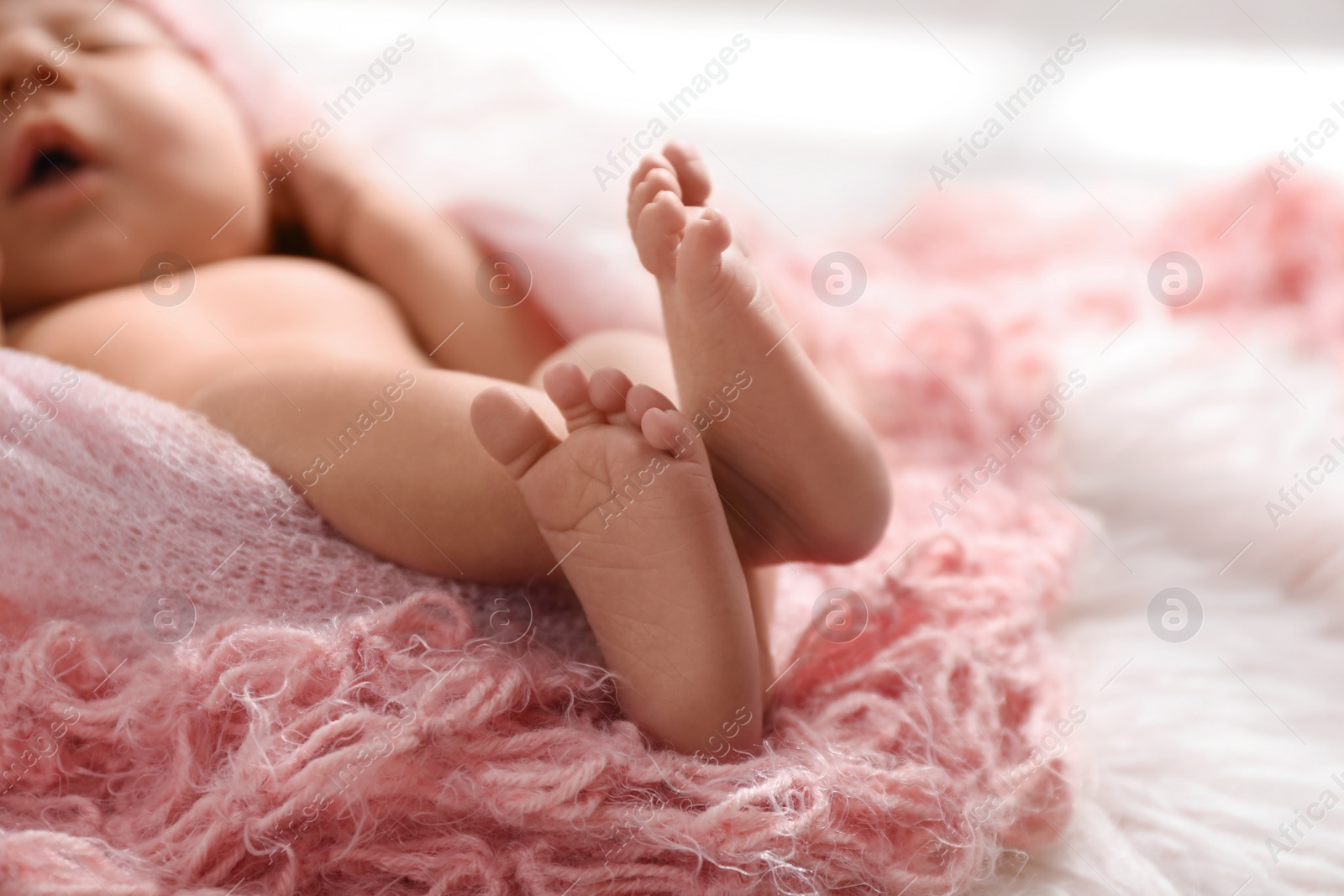 Photo of Newborn baby sleeping on fuzzy blanket, closeup