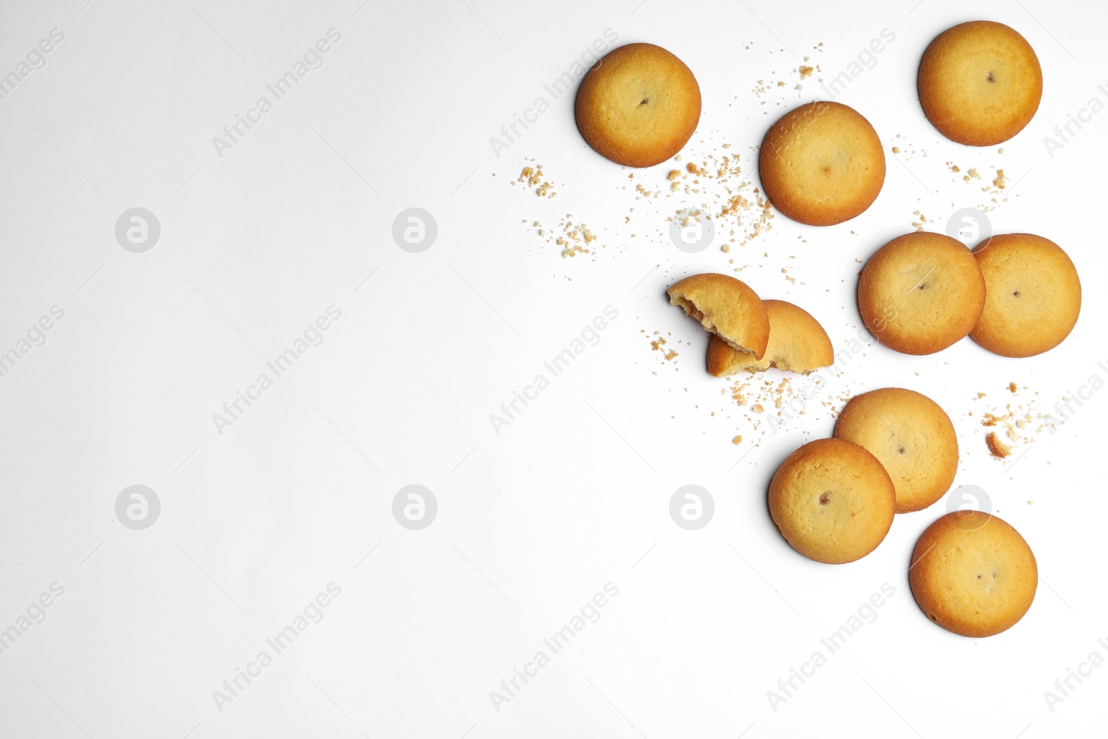 Photo of Tasty cookies and crumbles on white background, top view