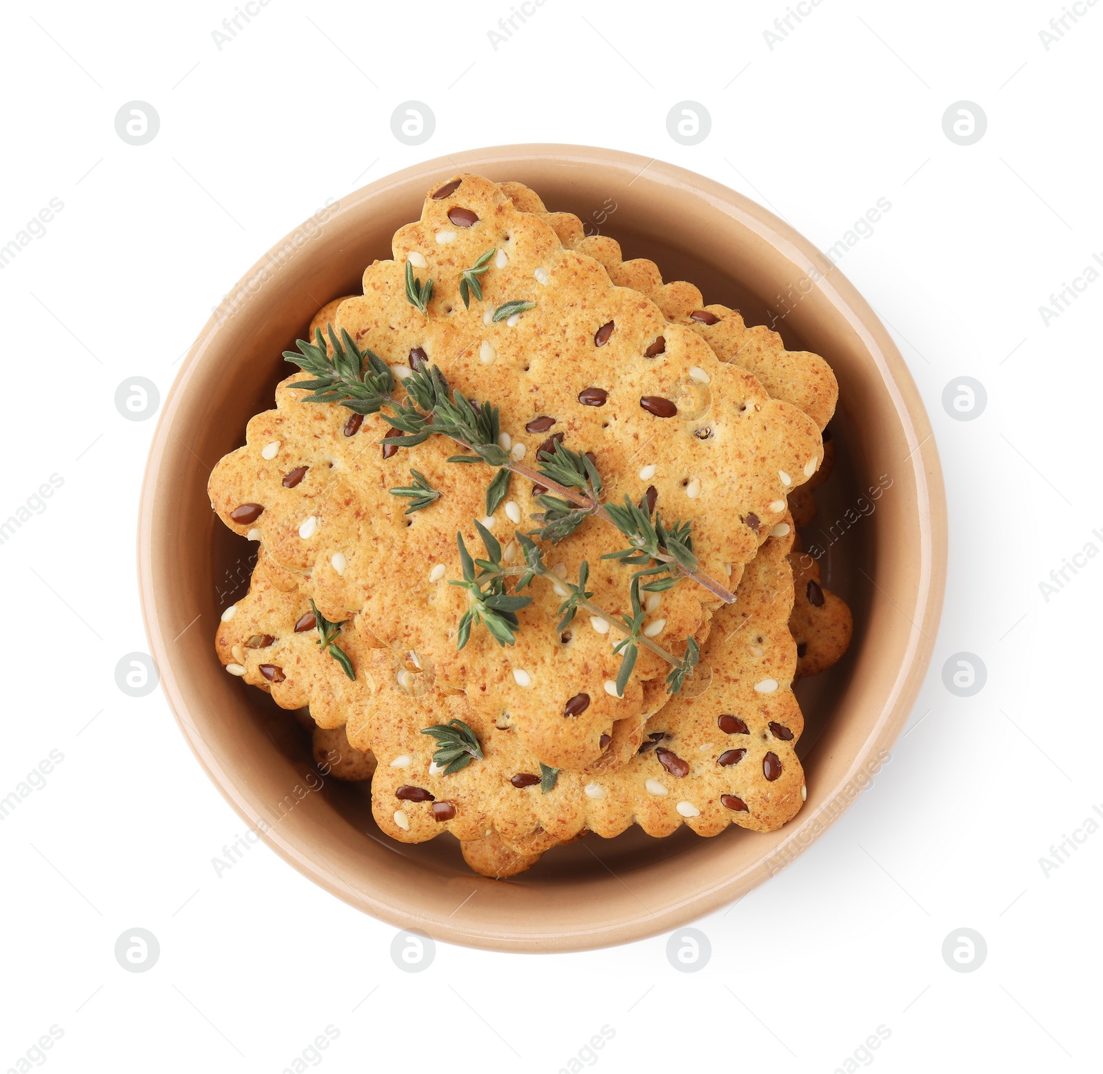 Photo of Cereal crackers with flax, sesame seeds and thyme in bowl isolated on white, top view