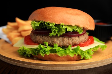 Photo of Tasty burger with vegetables, patty and cheese on wooden table, closeup