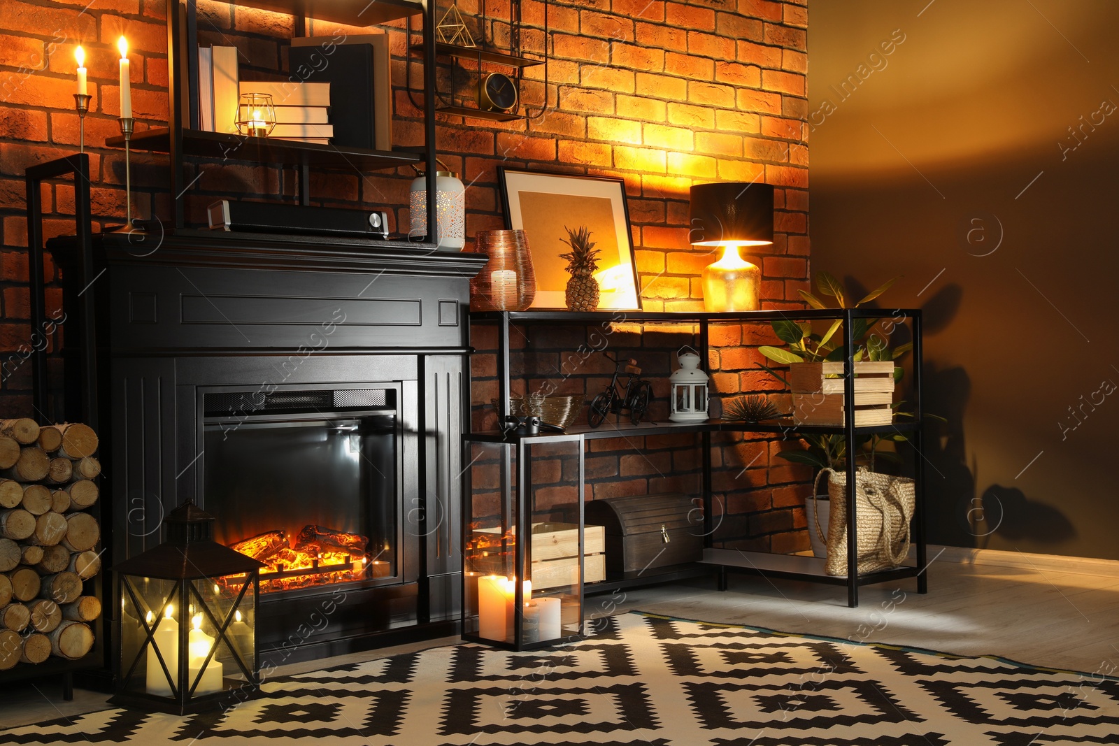 Photo of Beautiful fireplace and different decor in living room at night. Interior design