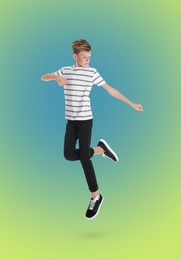 Image of Teenage boy jumping on color gradient background