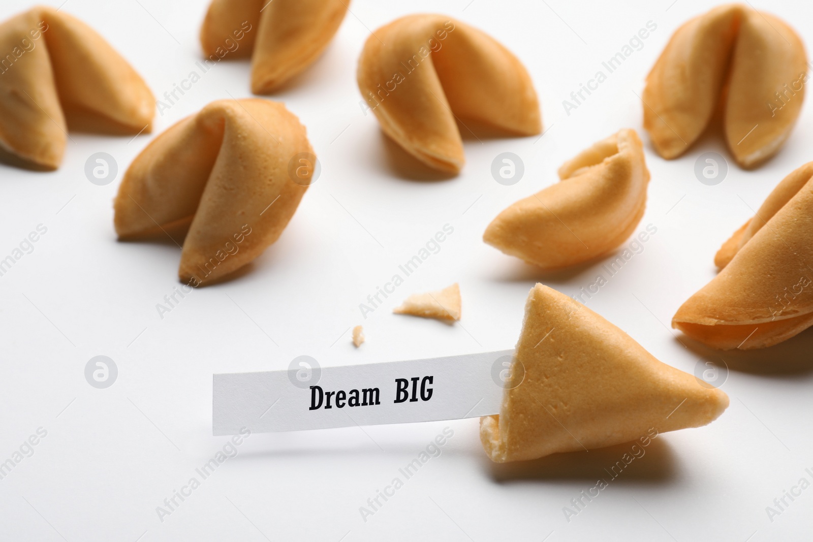 Image of Tasty fortune cookies with prediction Dream BIG on white background