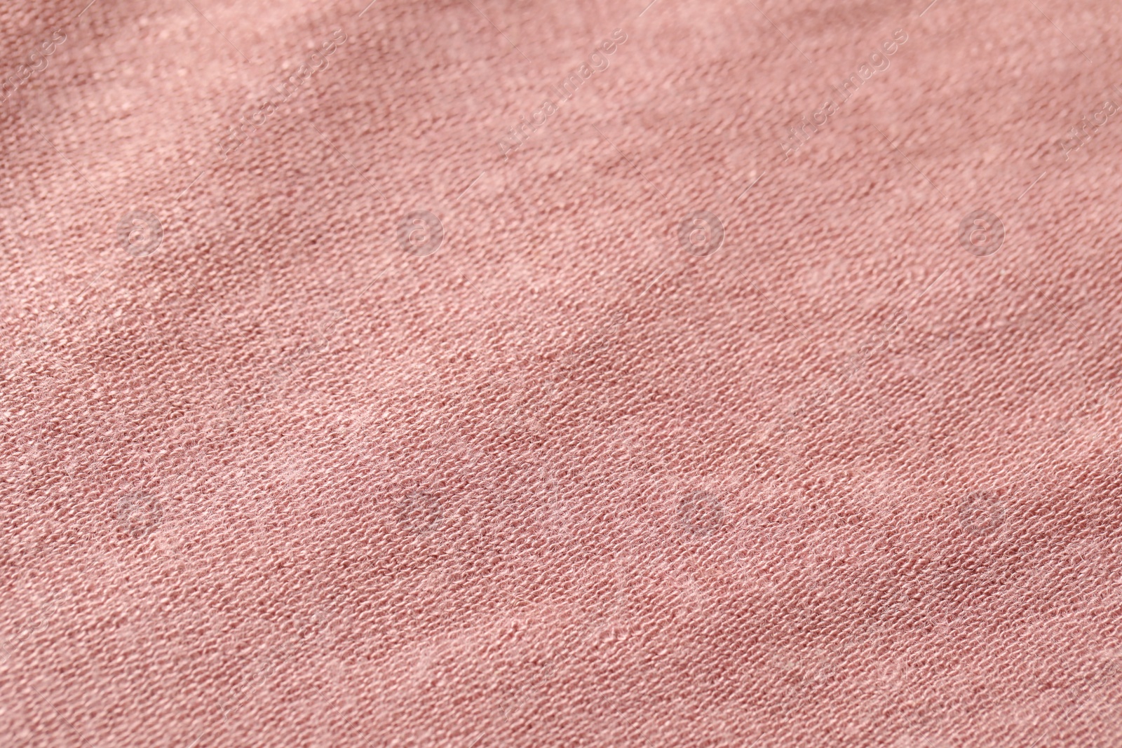 Photo of Texture of soft pink fabric as background, closeup