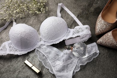 Photo of Flat lay composition with elegant white women's underwear on grey background