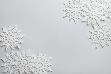 Beautiful snowflakes on white background, flat lay. Space for text