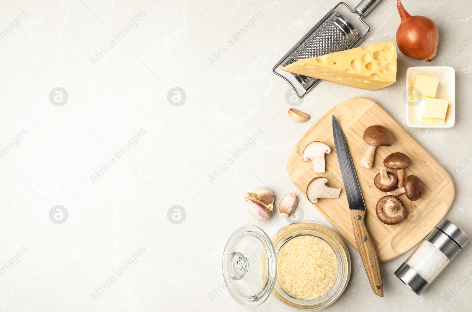 Photo of Flat lay composition with different ingredients on white table, space for text. Risotto recipe