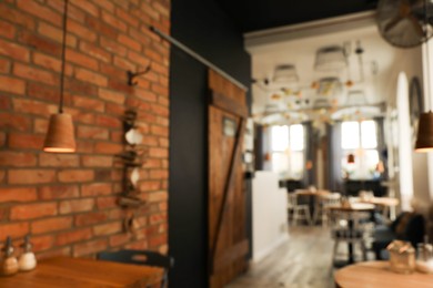 Photo of Stylish cafe interior with furniture, blurred view