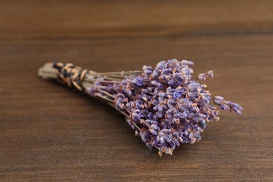 Bunch of dry lavender on wooden table, closeup