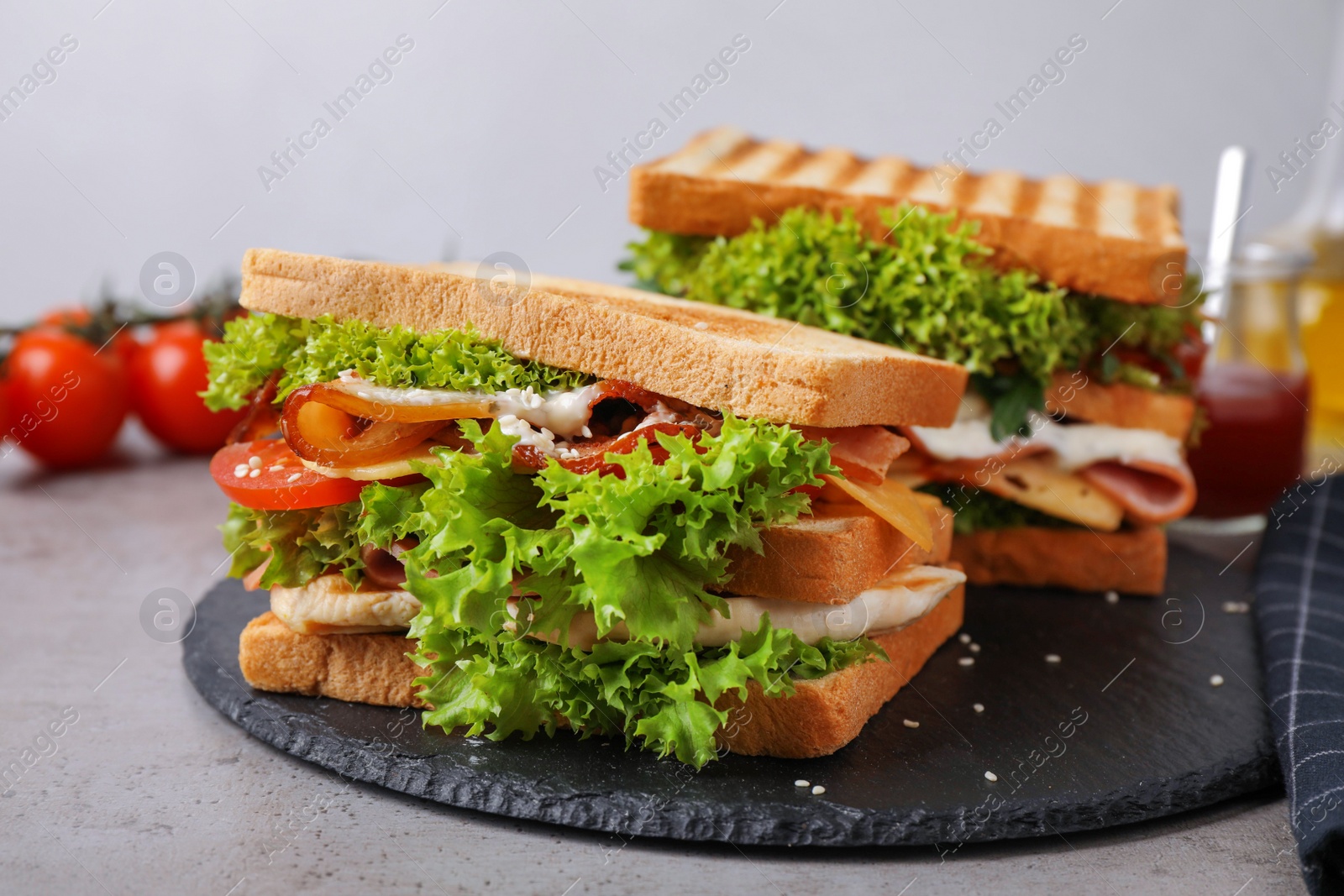 Photo of Freshly made sandwiches served on grey table